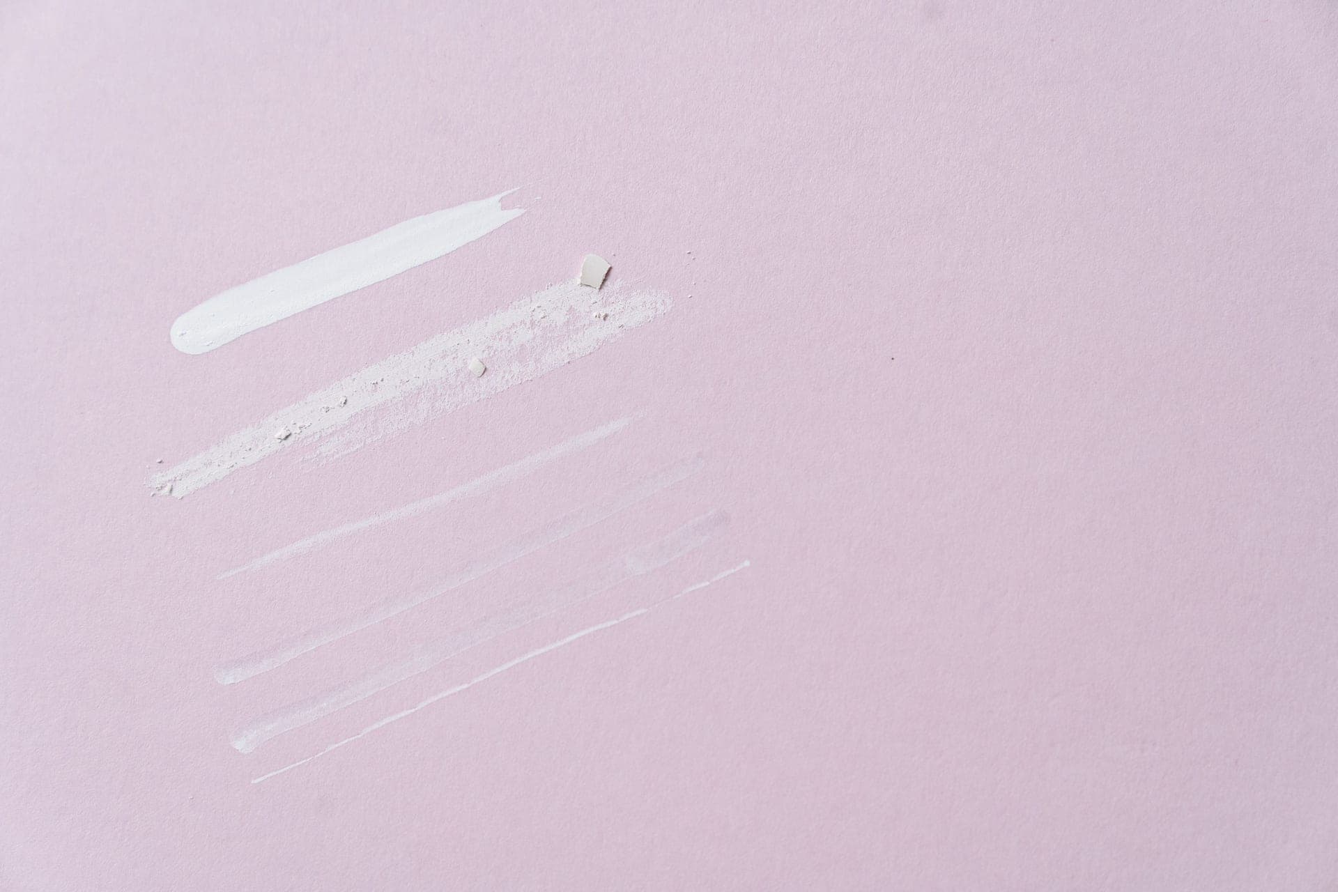 A clear gel exfoliant swatched on a neutral surface