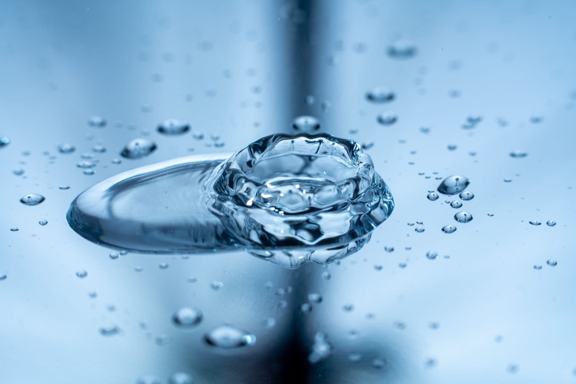 Water and light foam against a calm porcelain-toned background