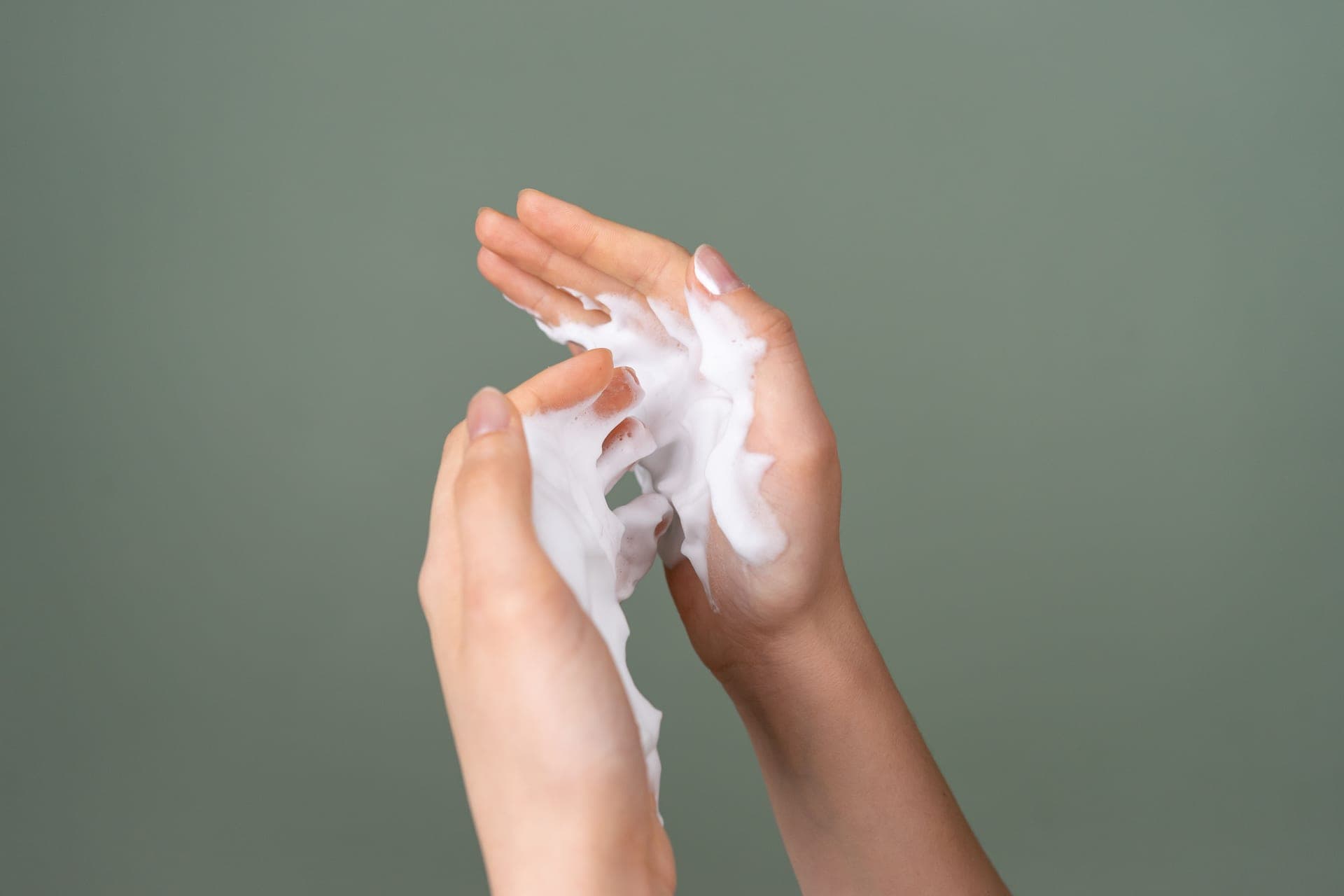 A swatch of white cream on a soft neutral background