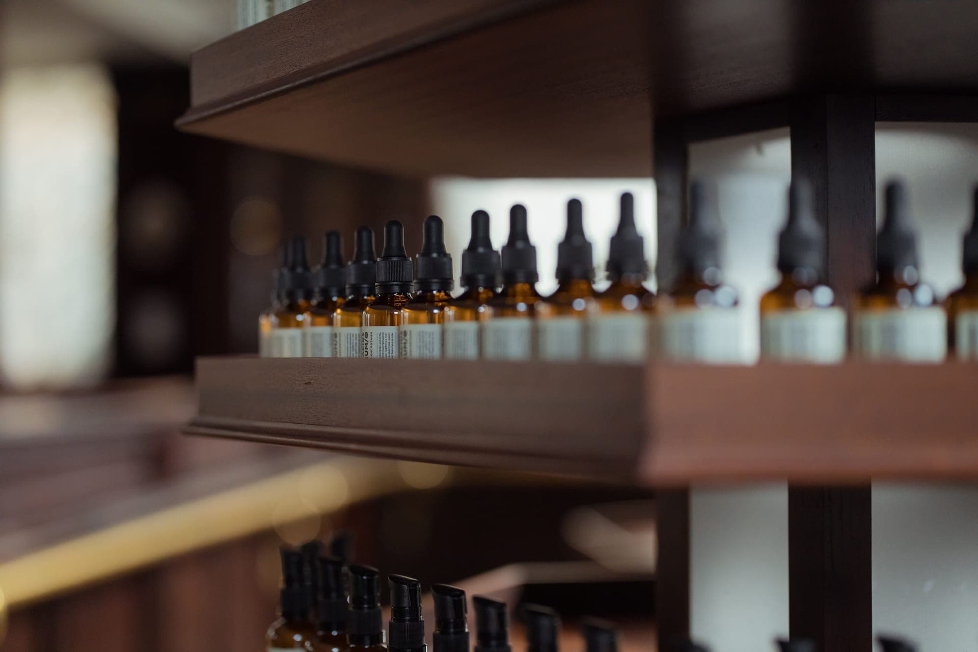 Glass pipettes and amber dropper bottles arranged on linen